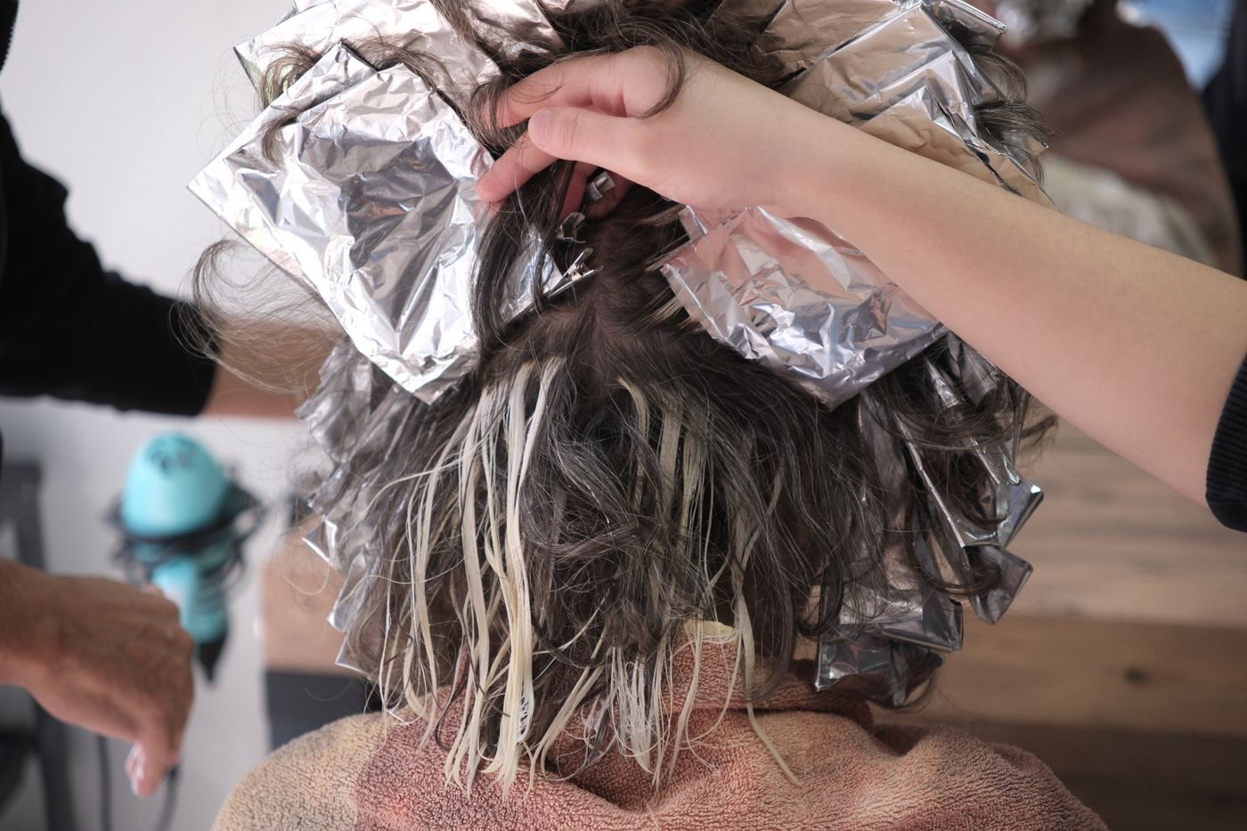 Foils being placed through a client&rsquo;s highlights