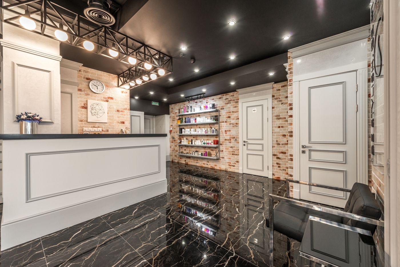 Warm salon interior with marble and bulb lighting