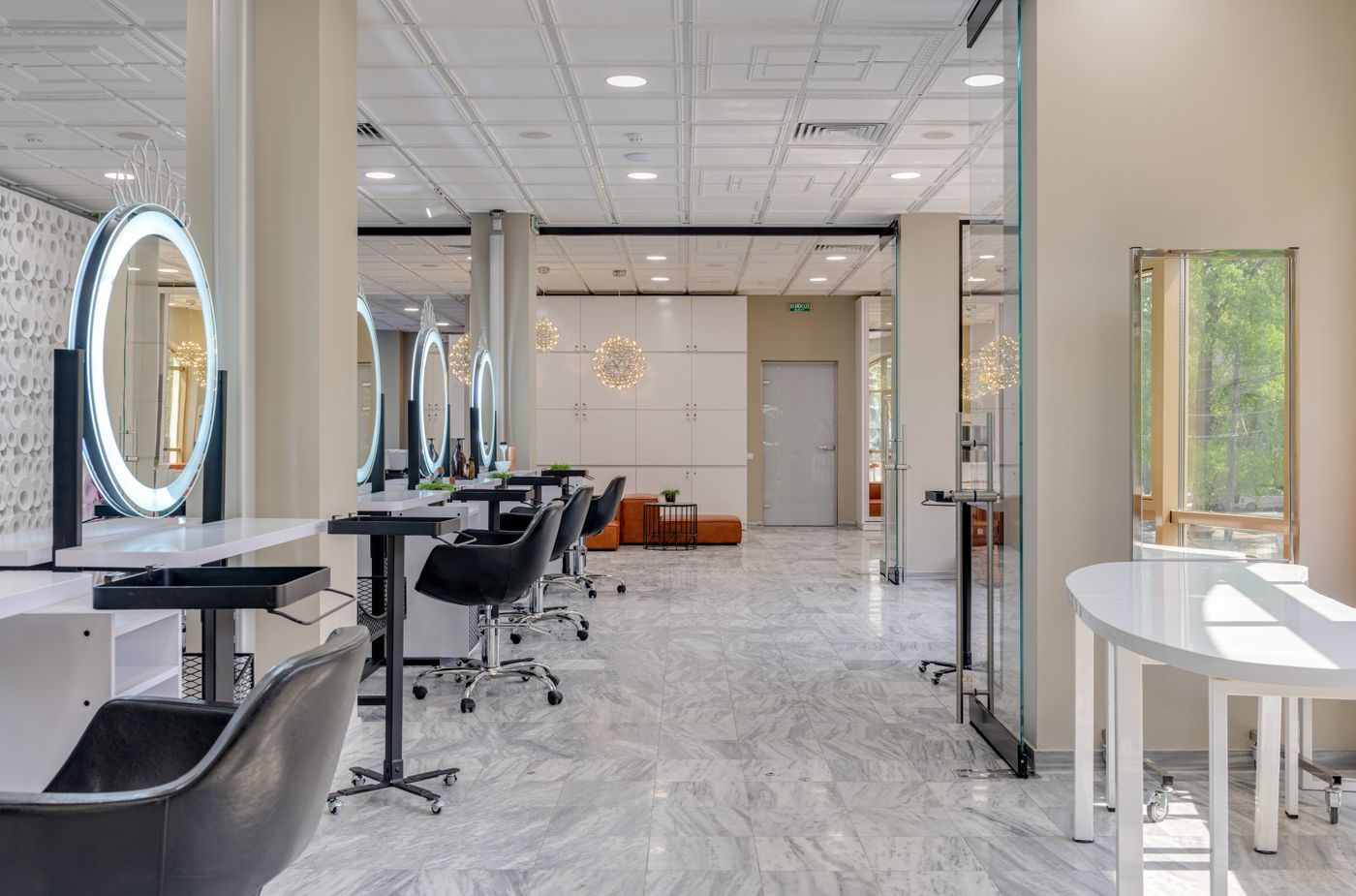 Bright salon floor with round lit mirrors
