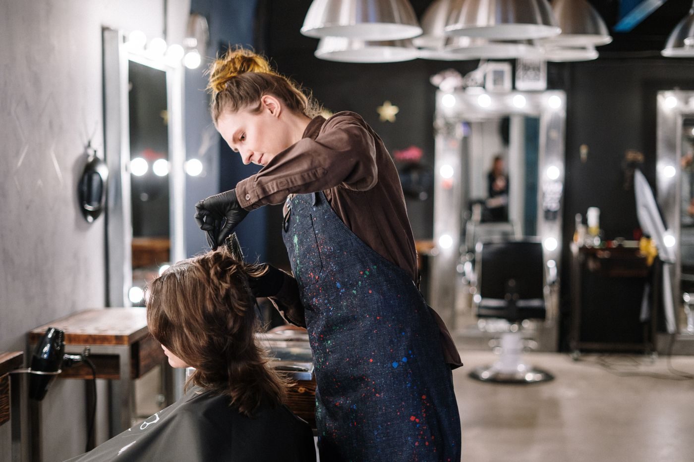 Stylist working through a client&rsquo;s hair